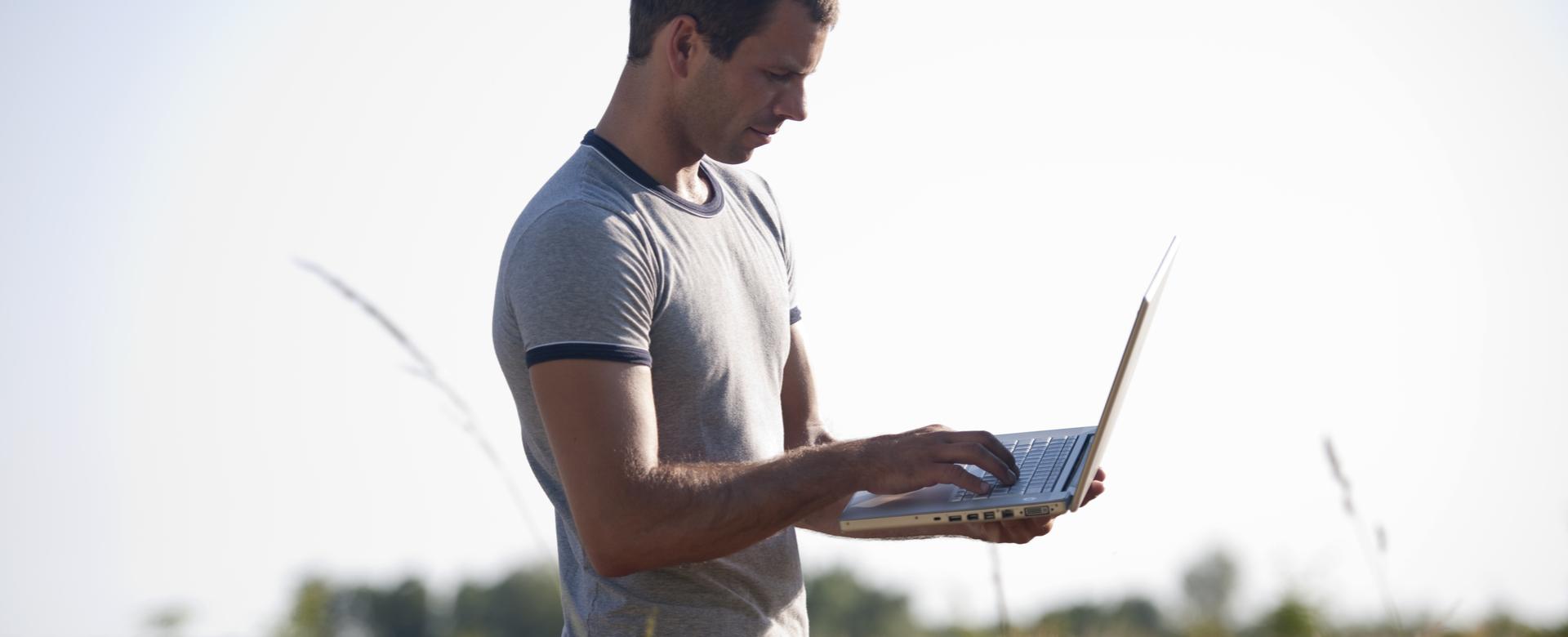 Worker on laptop in field